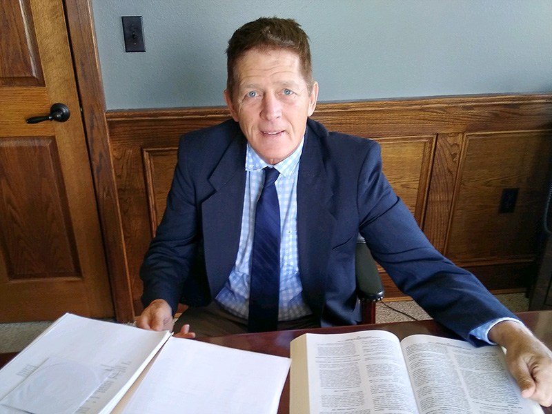 Attorney at Duffy Law Office working at a desk with legal documents in Thief River Falls, Minnesota.