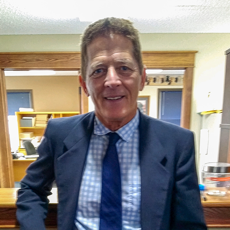 kevin-duffy Attorney Kevin T. Duffy of Duffy Law Office smiling inside the office in Thief River Falls, Minnesota.